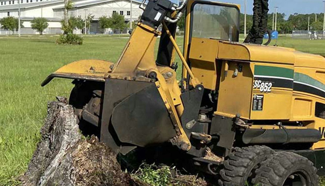 a tractor that is sitting in the grass